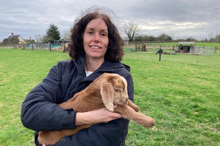 Image of Amanda holding a small goat